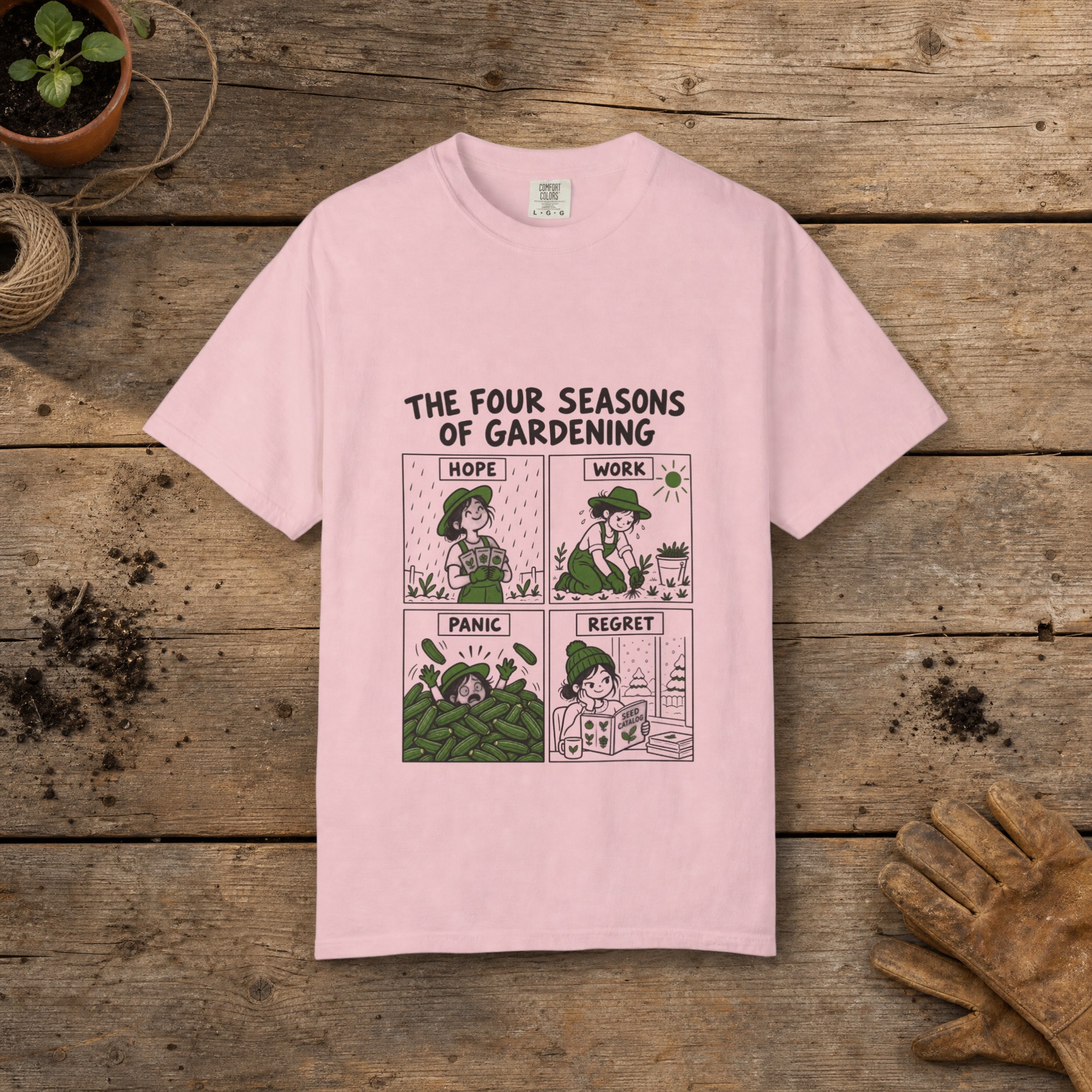 Four Seasons of Gardening gardening t-shirt in Blossom, laid flat on a potting bench with gardening gloves and a trowel