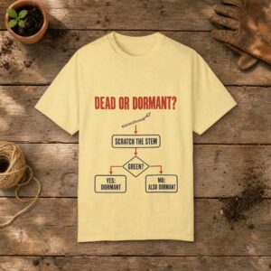 Dead or Dormant Flowchart gardening t-shirt in Butter, laid flat on a potting bench with gardening gloves and a trowel