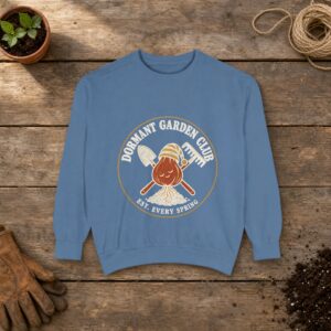 Dormant Garden Club Crest Sweatshirt in Blue Jean, a crewneck sweatshirt on a potting bench