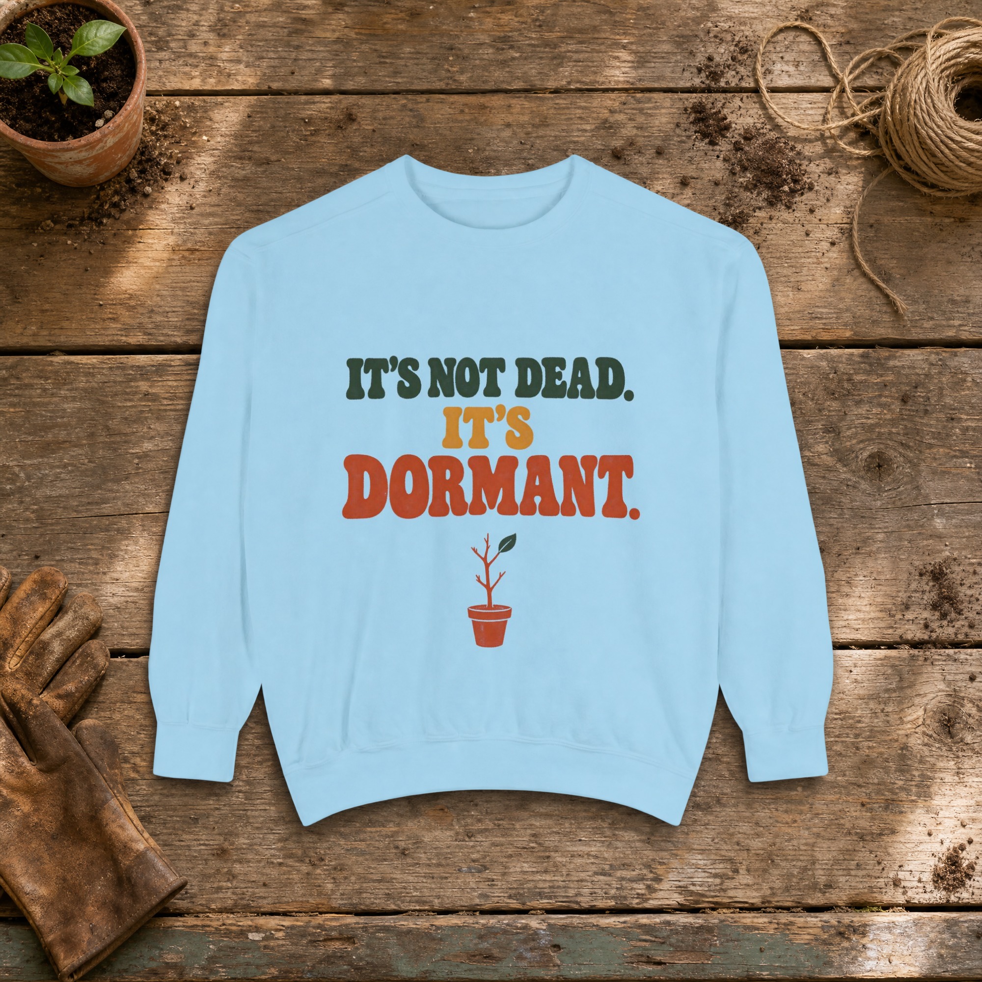 It's Not Dead. It's Dormant. Sweatshirt in Chambray, a crewneck sweatshirt on a potting bench