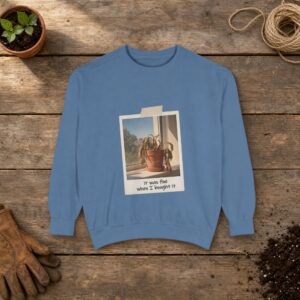 It Was Fine When I Bought It Sweatshirt in Blue Jean, a crewneck sweatshirt on a potting bench