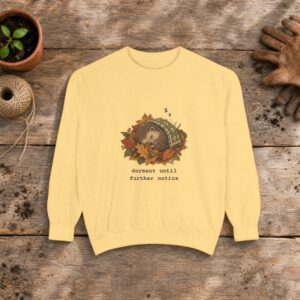 Dormant Until Further Notice Sweatshirt in Butter, a crewneck sweatshirt on a potting bench