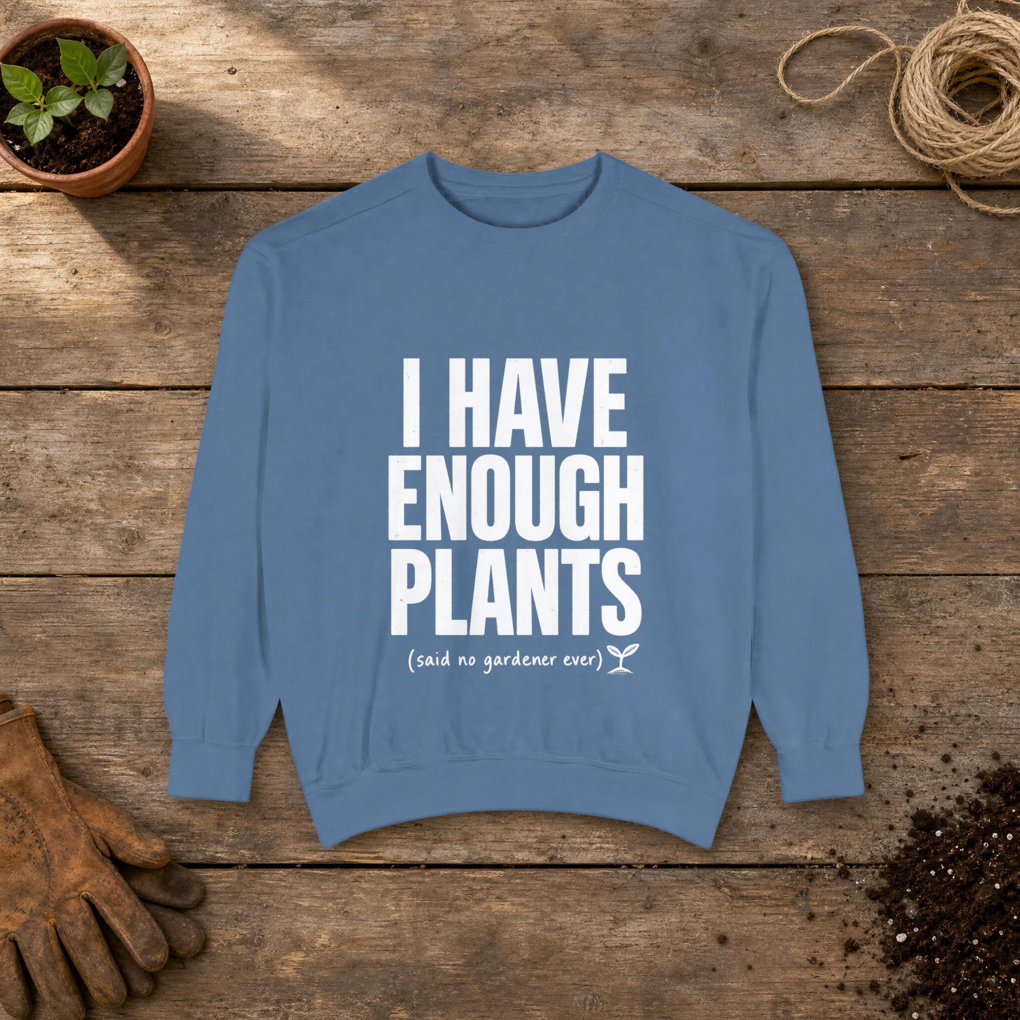 I Have Enough Plants Sweatshirt in Blue Jean, a crewneck sweatshirt on a potting bench