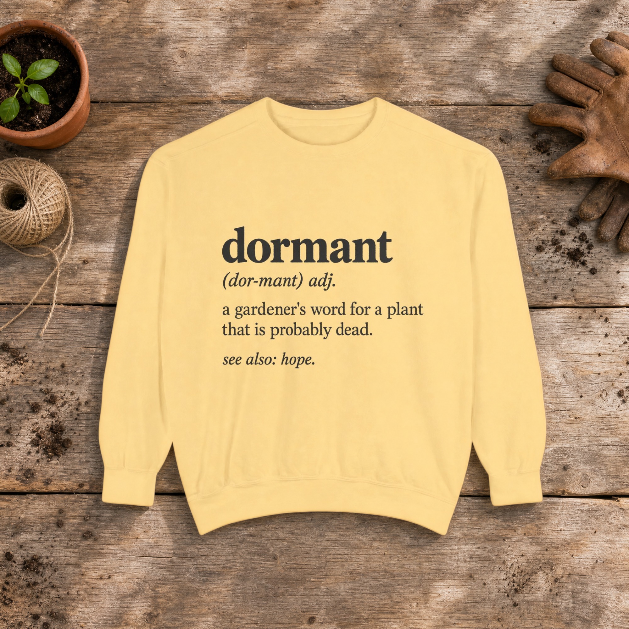 Dormant Definition Sweatshirt in Butter, a crewneck sweatshirt on a potting bench