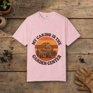 My Cardio Is the Garden Center gardening t-shirt in Blossom, laid flat on a potting bench with gardening gloves and a trowel