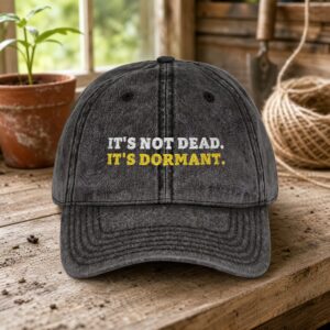 It's Not Dead. It's Dormant. Vintage Cap in Black, a vintage washed cap on a potting bench